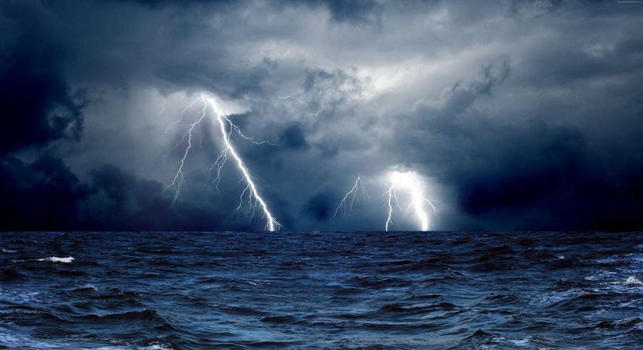 Stormy ocean with lightning flashing through dark clouds. — Thunderstorm Background