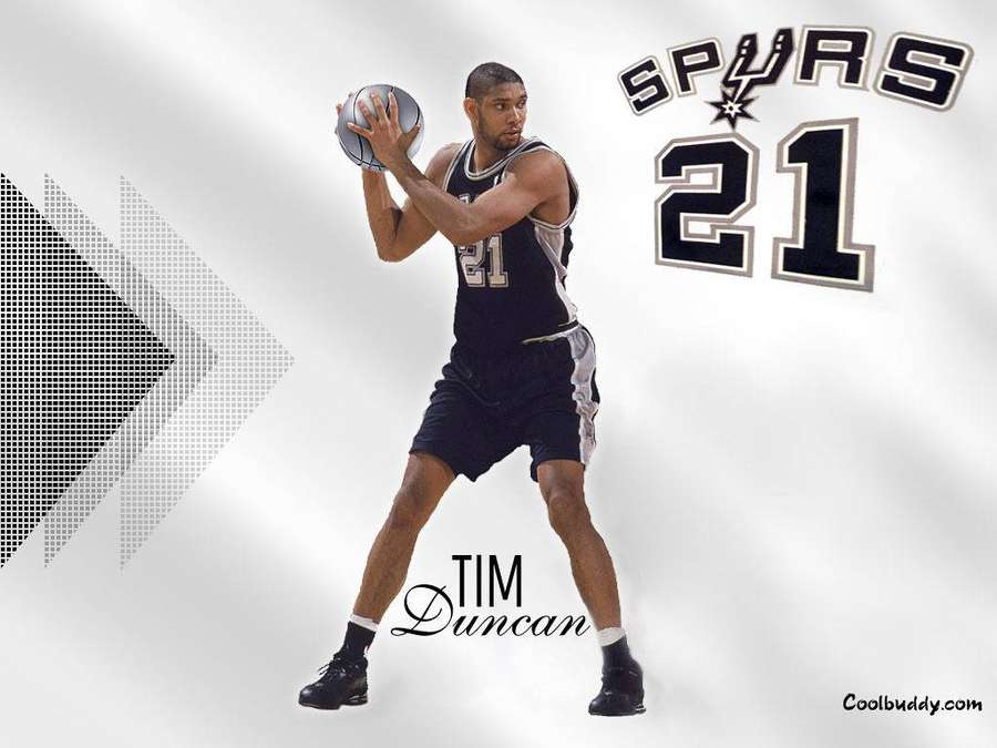 Tim Duncan in black Spurs jersey number 21 holding a basketball in a shooting stance. — Tim Duncan Wallpaper