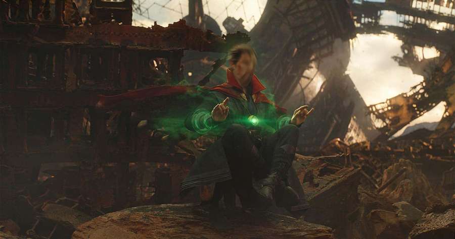 Superhero casting green magic in a ruined city at sunset. — Time Stone Wallpaper