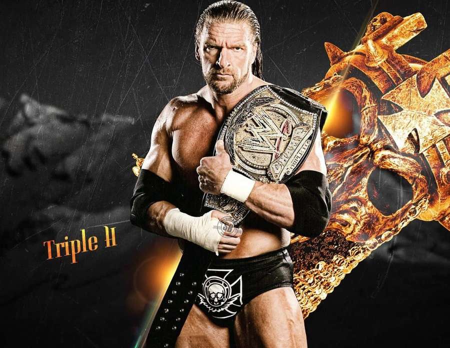 Wrestler Triple H holding a championship belt with a fiery skull graphic behind him. — Triple h Wallpaper