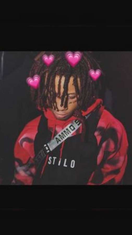 Person with dreadlocks wearing a red and black hoodie with floating pink hearts. — Trippie Wallpaper