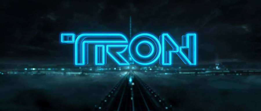 Glowing blue TRON logo in a dark futuristic city with light trails. — Tron Background