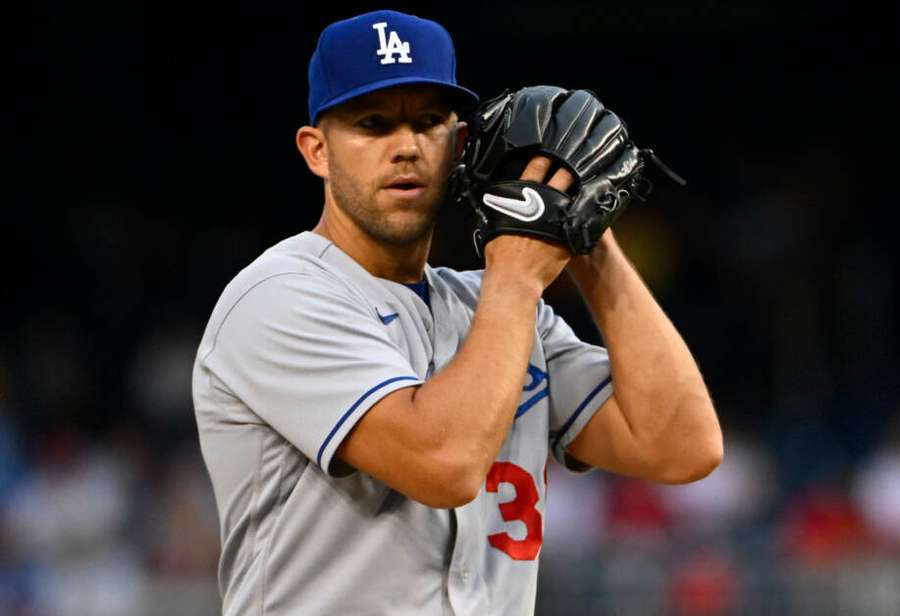 Baseball pitcher in Dodgers uniform preparing to throw at night. — Tyler Anderson Wallpaper