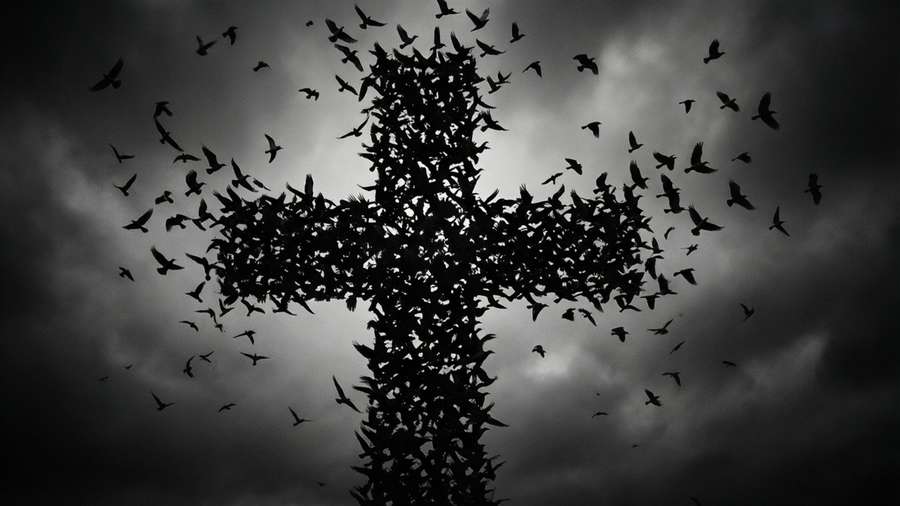A nature wallpaper of an upside-down cross formed by birds. — Upside Down Cross Wallpaper