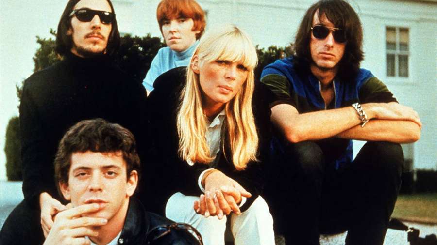 The Rolling Stones band members posing outdoors in 1970s style. — Velvet Underground Wallpaper