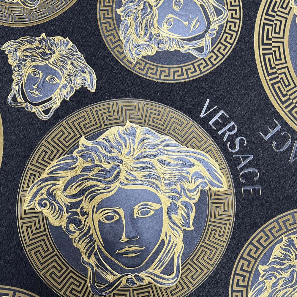 Versace branded fabric with gold Medusa heads and Greek key patterns on dark blue background. — Versace Background