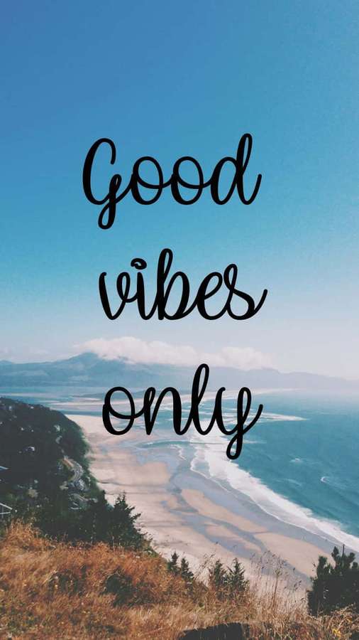 Coastal beach scene with mountains and ocean waves under a blue sky with text 'Good vibes only'. — Vibes iPhone Wallpaper