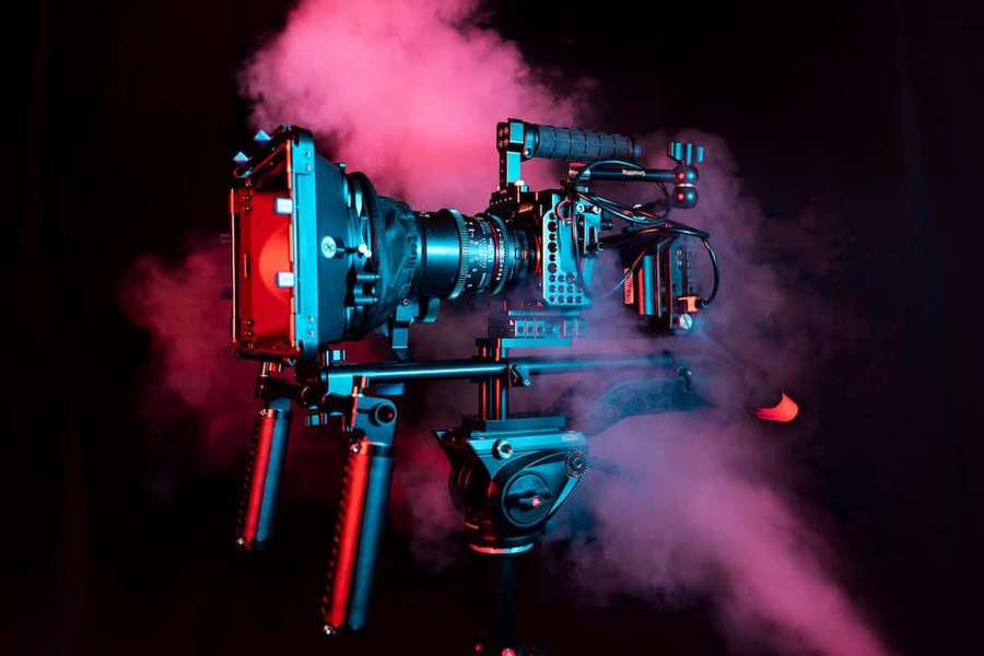 Professional film camera in neon lights with smoke effects. — Video Picture