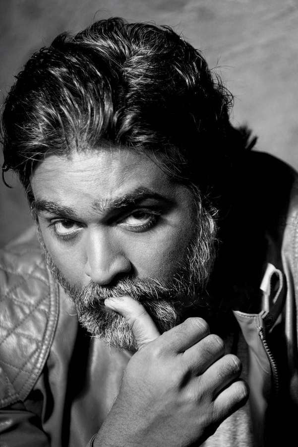 A bearded man in a leather jacket stares intently with finger on lips. — Vijay Sethupathi Master Wallpaper