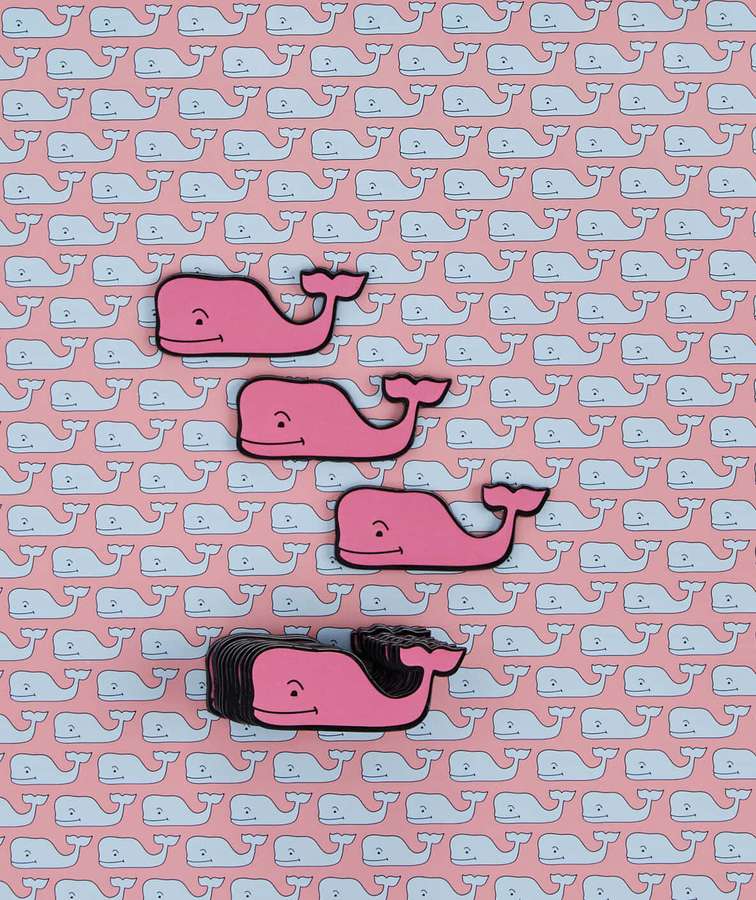 Pink cartoon whales with black outlines arranged diagonally on a repeating whale pattern background. — Vineyard Vines Wallpaper