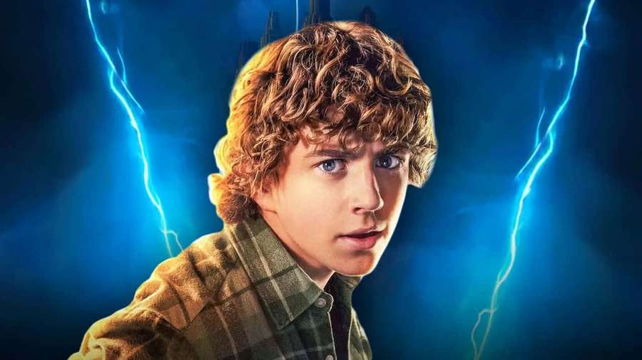 Young man with curly hair and plaid shirt surrounded by electric blue lightning. — Walker Scobell Wallpaper