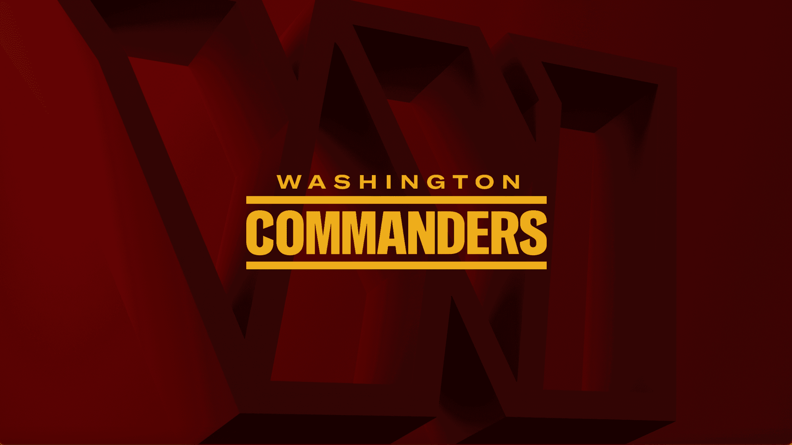 Washington Commanders football team logo in gold on a red geometric background. — Washington Commanders Wallpaper