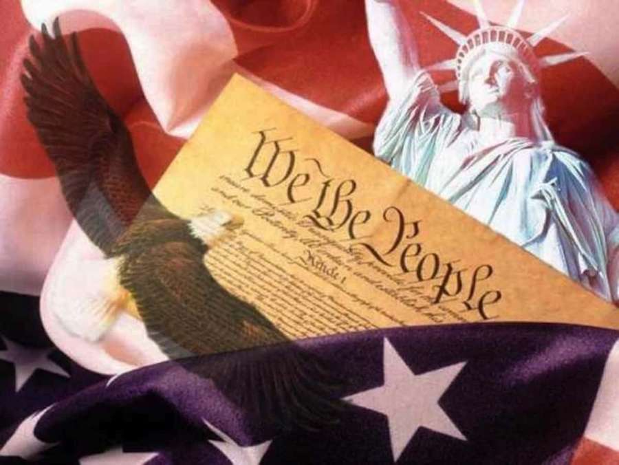 Bald eagle flying over Constitution text with Statue of Liberty and American flag. — We The People Wallpaper