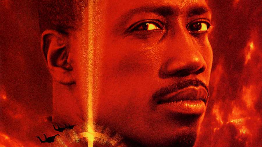 Close-up portrait of a man with glowing eyes against a fiery red background. — Wesley Snipes Wallpaper