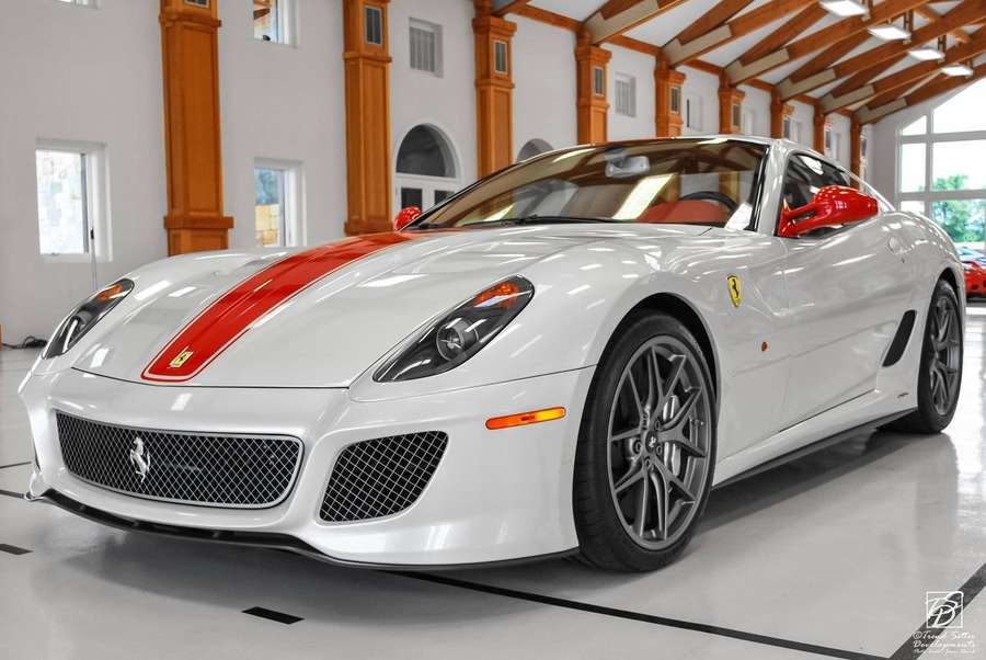 White Ferrari sports car with red stripe parked in a luxury garage. — White Ferrari Wallpaper