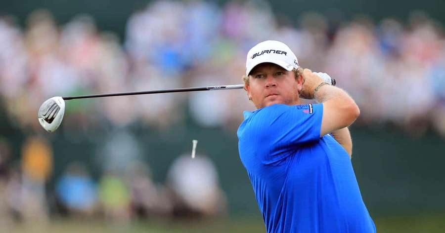 Professional golfer mid-swing at a tournament with spectators in background. — William Mcgirt Wallpaper