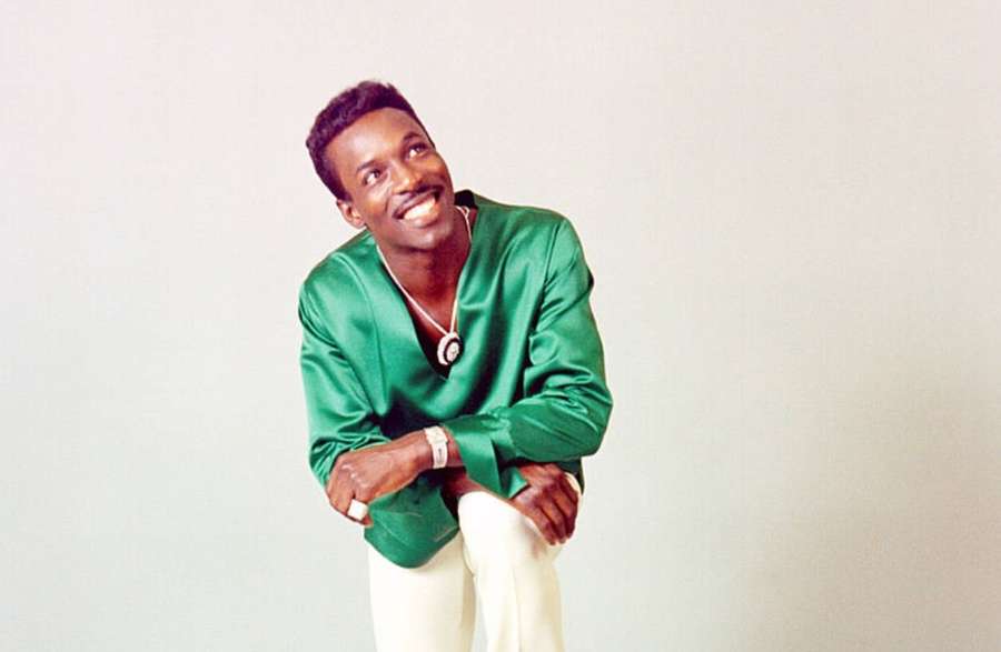 A smiling man in a green shirt posing in a studio — Wilson Pickett Wallpaper