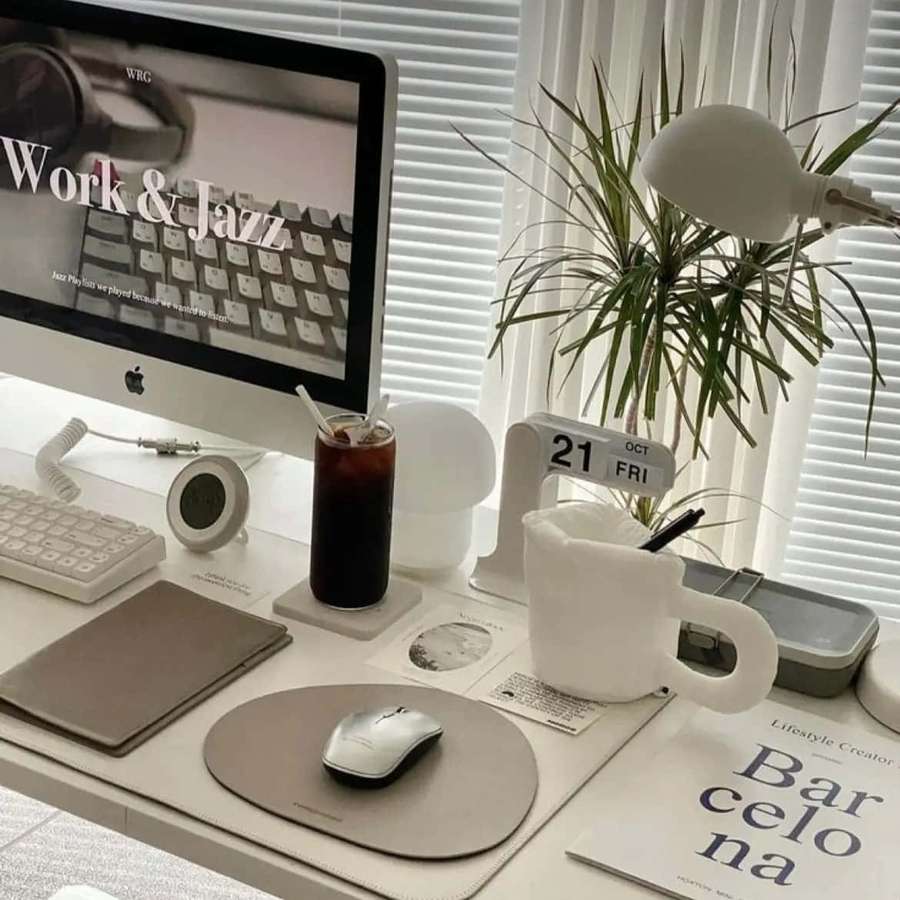 Clean minimalist home office desk with plant lamp coffee and calendar. — Work Aesthetic Wallpaper