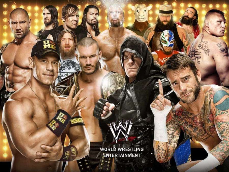 WWE wrestlers in action poses with championship belts and tattoos. — WWE Picture