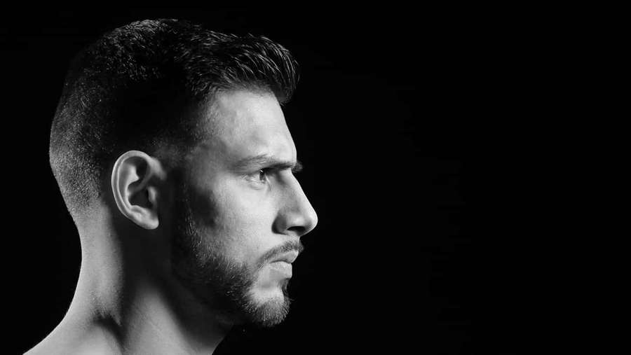 Black and white studio portrait of a bearded man in profile. — Yair Rodríguez Wallpaper