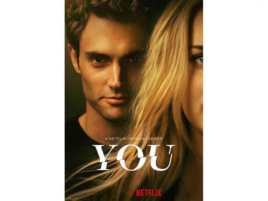 Close-up portrait of a man and woman with intense expressions, Netflix series title 'YOU' displayed. — You Wallpaper