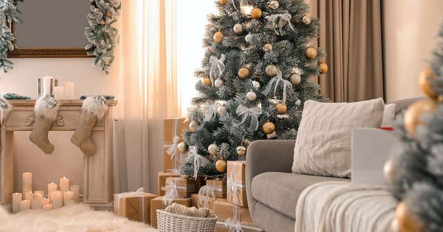 Cozy christmas living room with decorated tree glowing candles and wrapped gifts. — Zoom Christmas Background