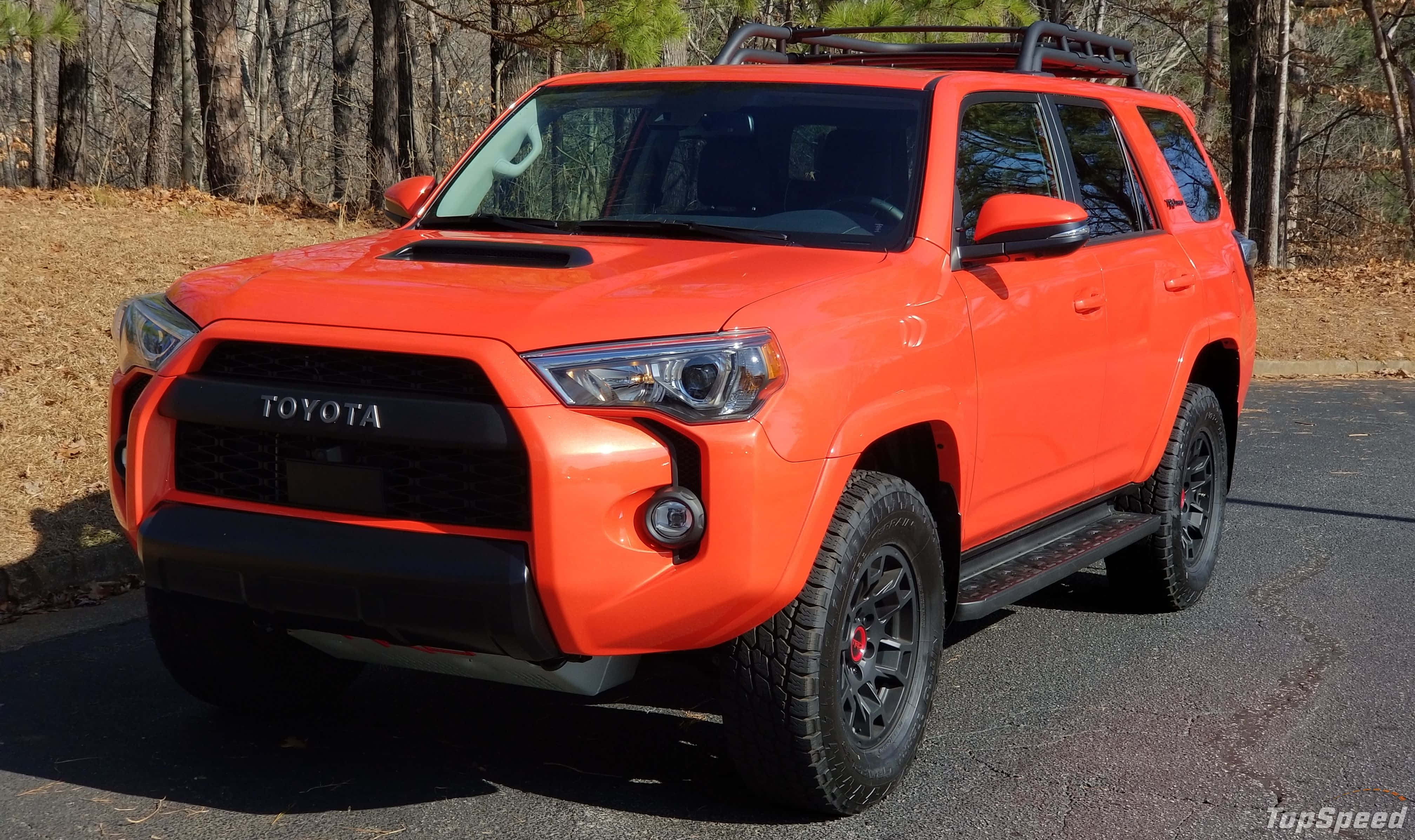 Download The Orange Toyota 4runner Is Parked On The Road