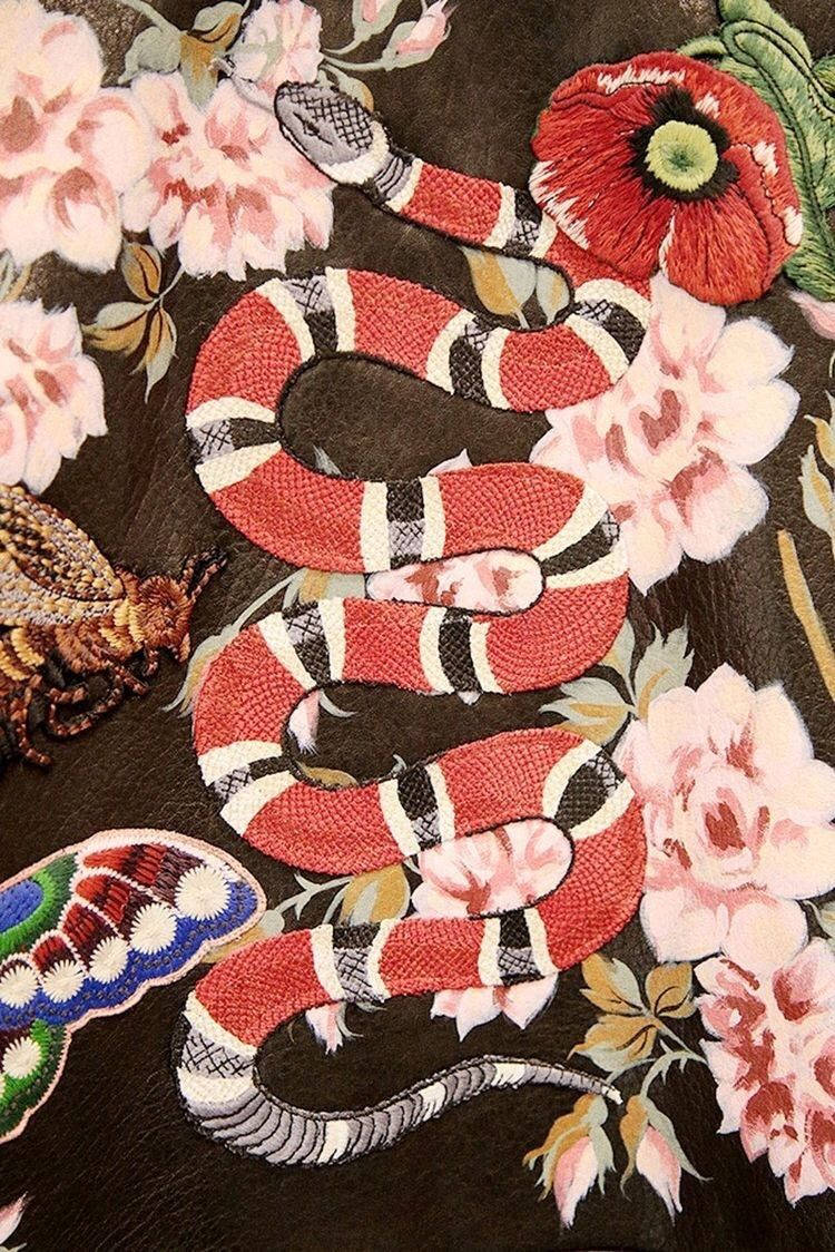 A Black And Red Embroidered Snake On A Black Background Background