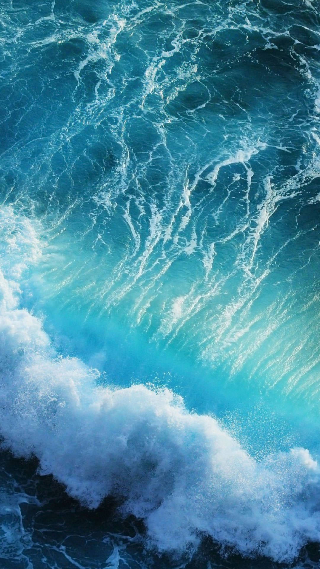 A Blue Wave Crashing Into The Ocean Background