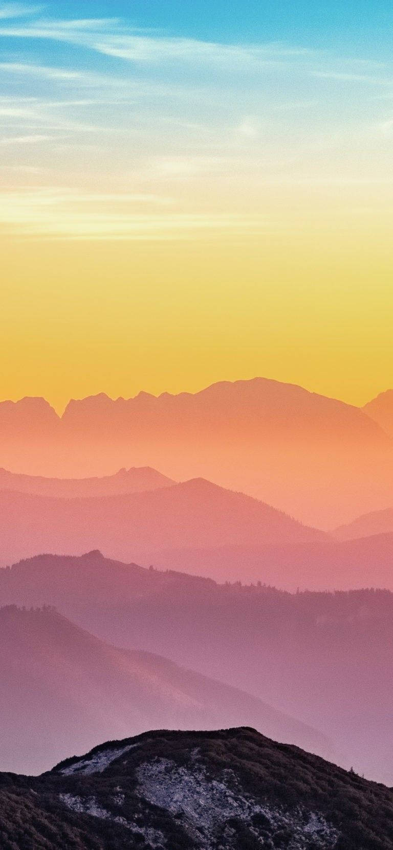A Colorful Sunset Over The Mountains Background