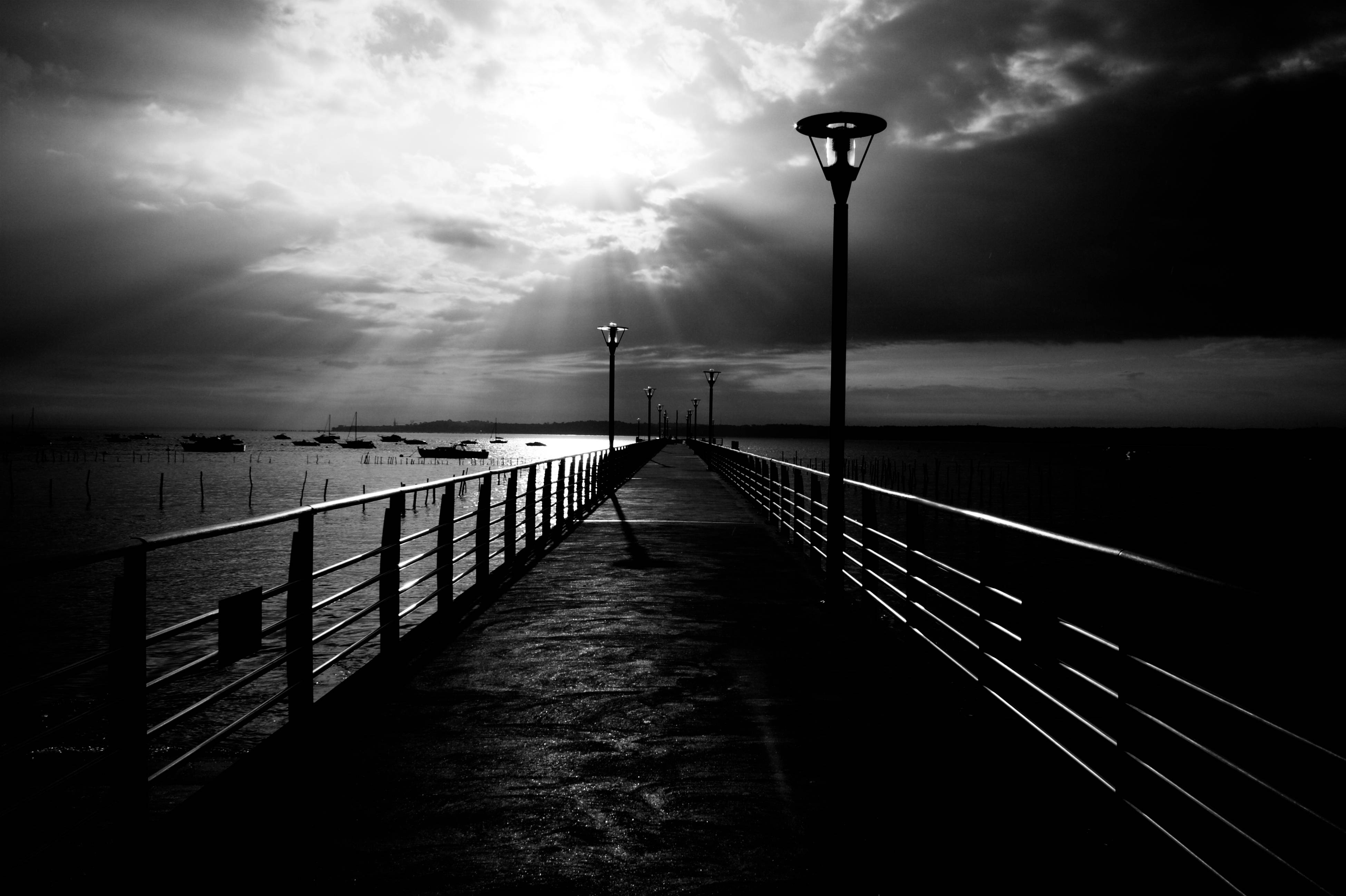 A Pier With A Light On It Background