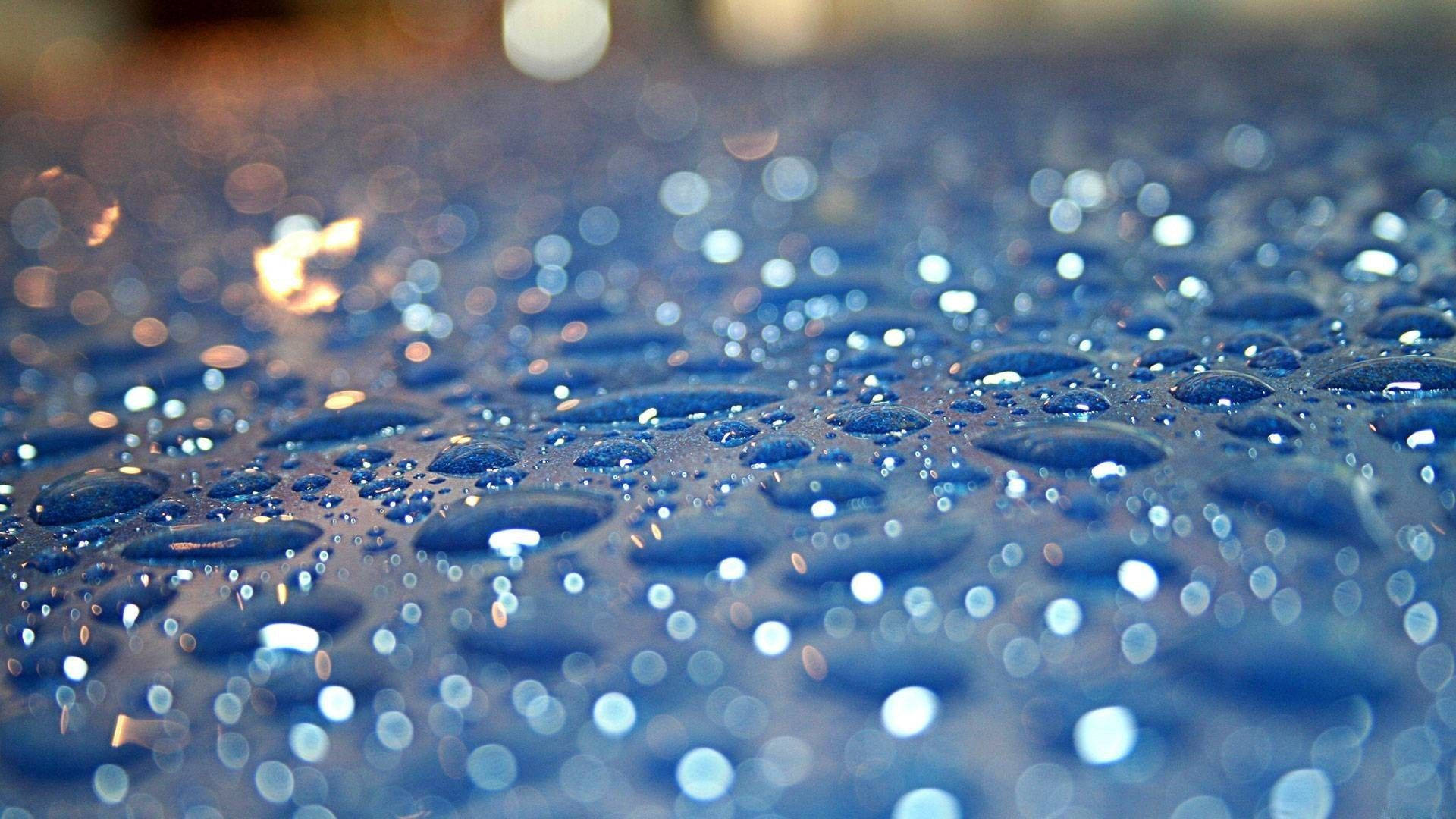 Download Beautiful Rain Droplets On A Surface Wallpaper Wallpapers.com ...