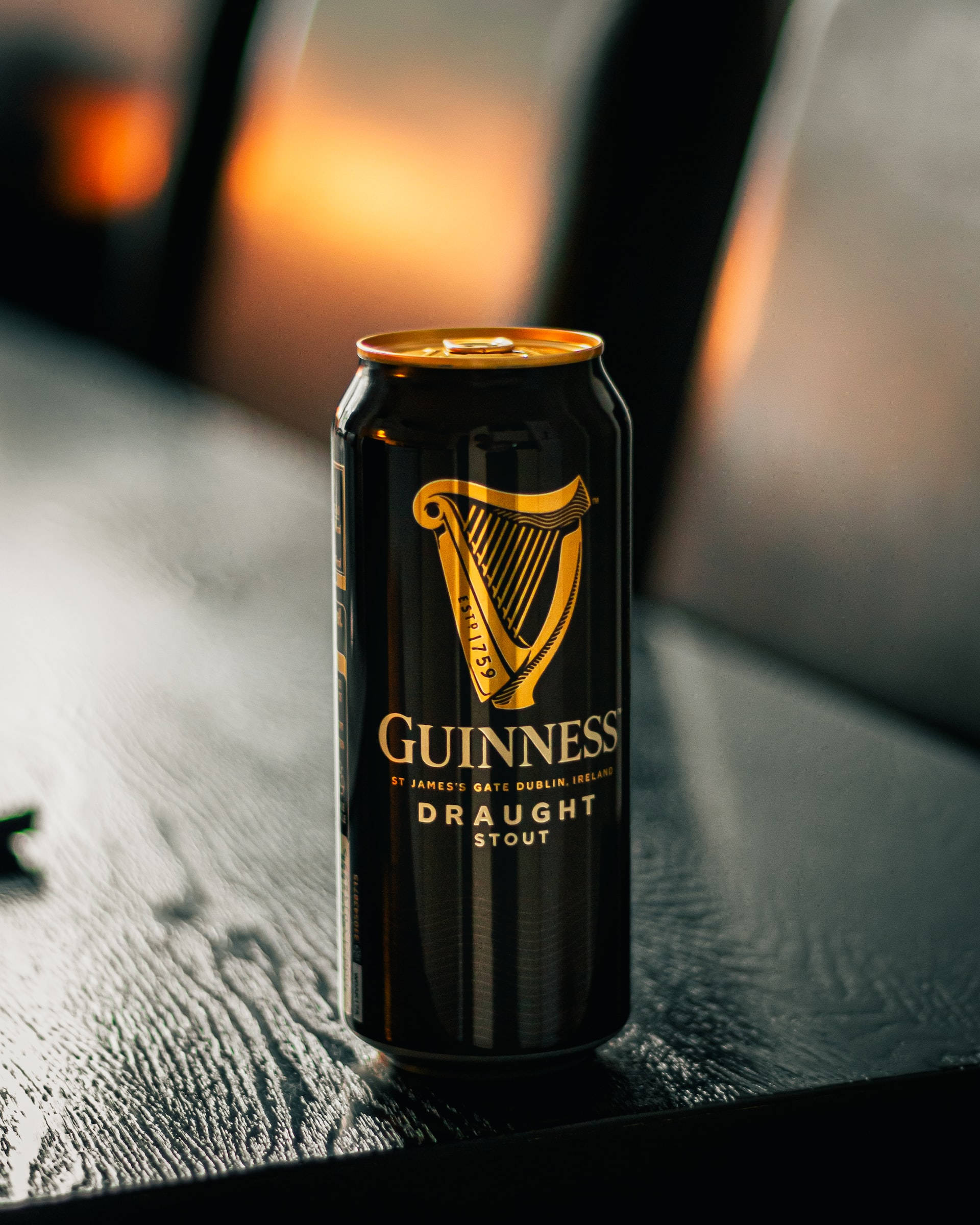 Download Irish Dry Stout Guinness Near Fireplace Wallpaper | Wallpapers.com