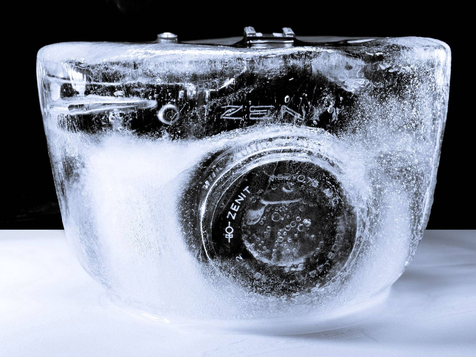 Frozen Camera In Ice Background