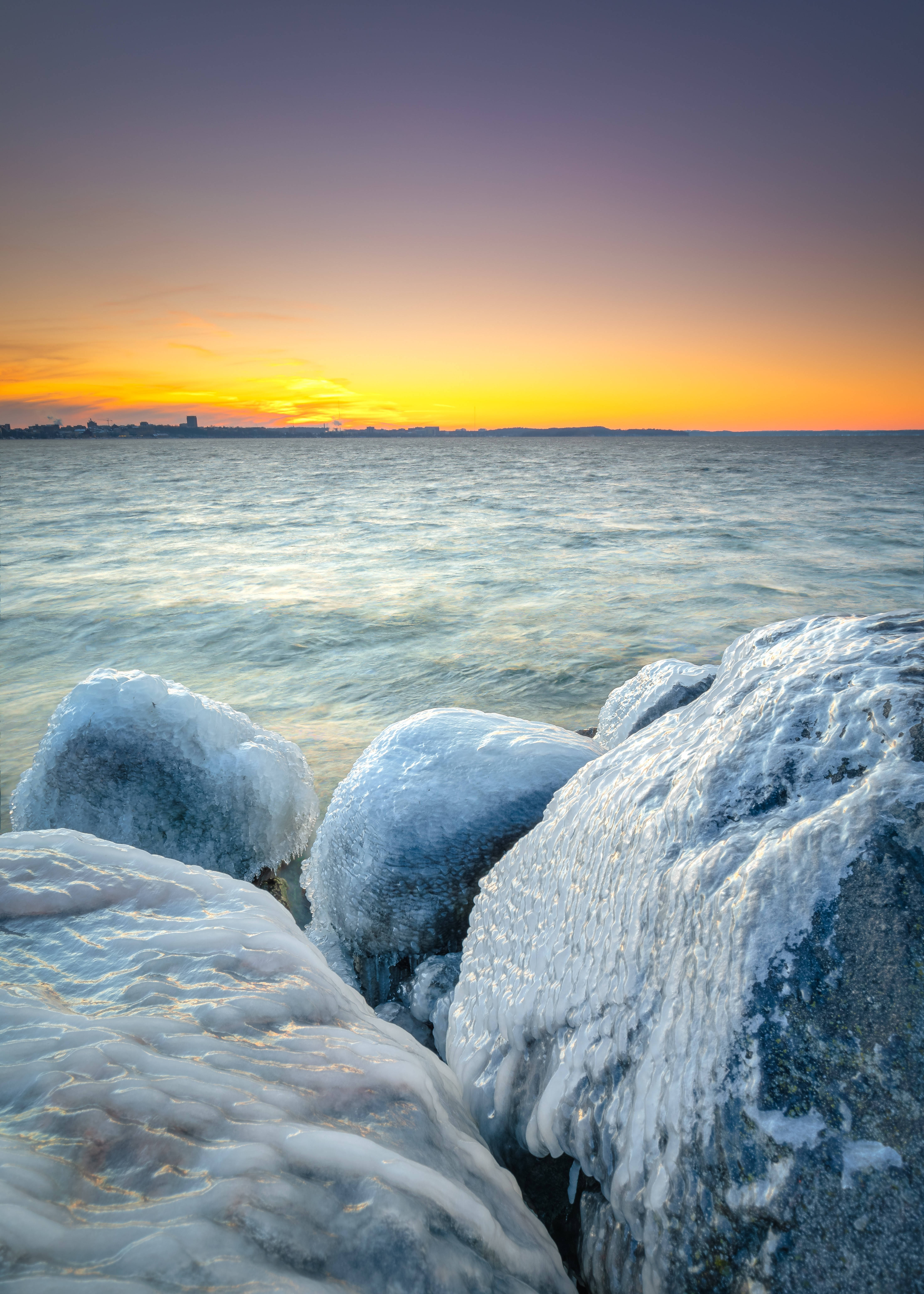 Frozen Stones By Coast Background