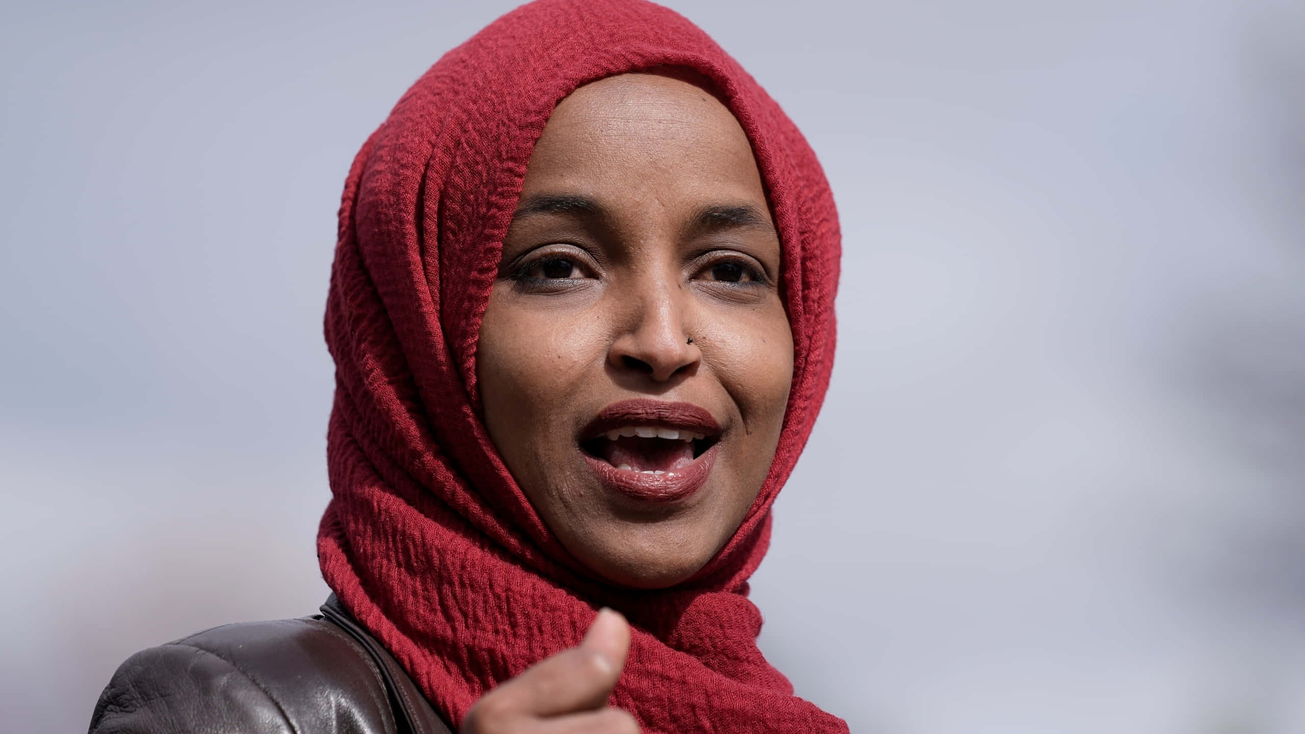 Download Ilhan Omar Mid-speech Wallpaper | Wallpapers.com