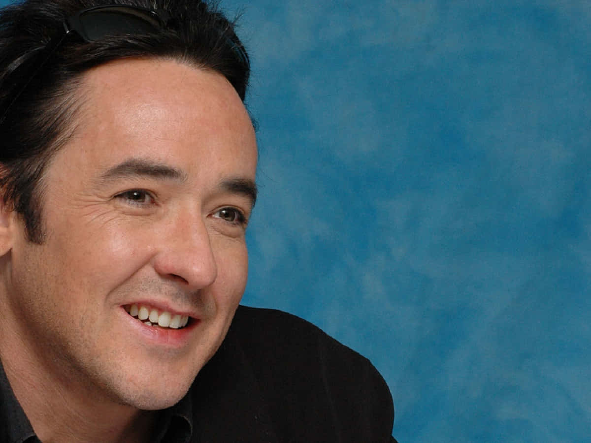 Download John Cusack posing for a portrait Wallpaper | Wallpapers.com