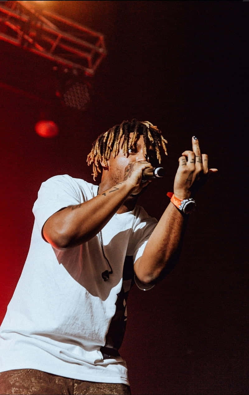 Download Juice Wrld playing an electrifying show at a concert Wallpaper