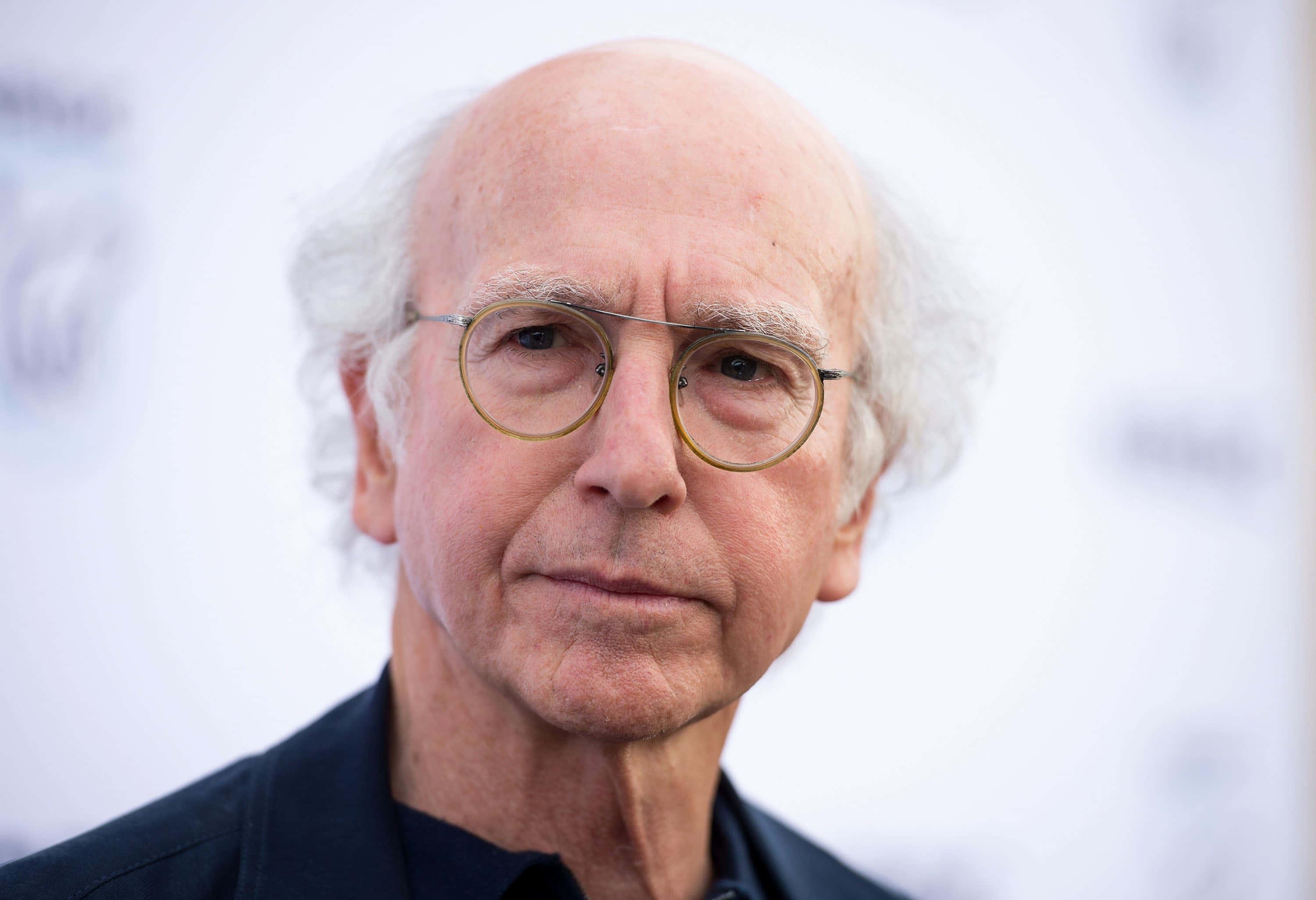 Download Larry David in a classic "Curb Your Enthusiasm" pose Wallpaper