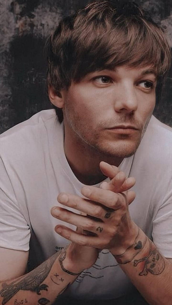 Download Louis Tomlinson Hands Clasped Wallpaper | Wallpapers.com