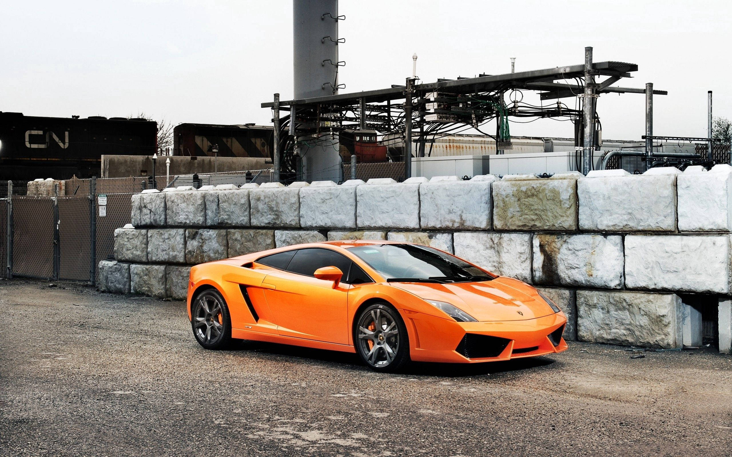 Orange Lamborghini Gallardo On Industrial Area Background