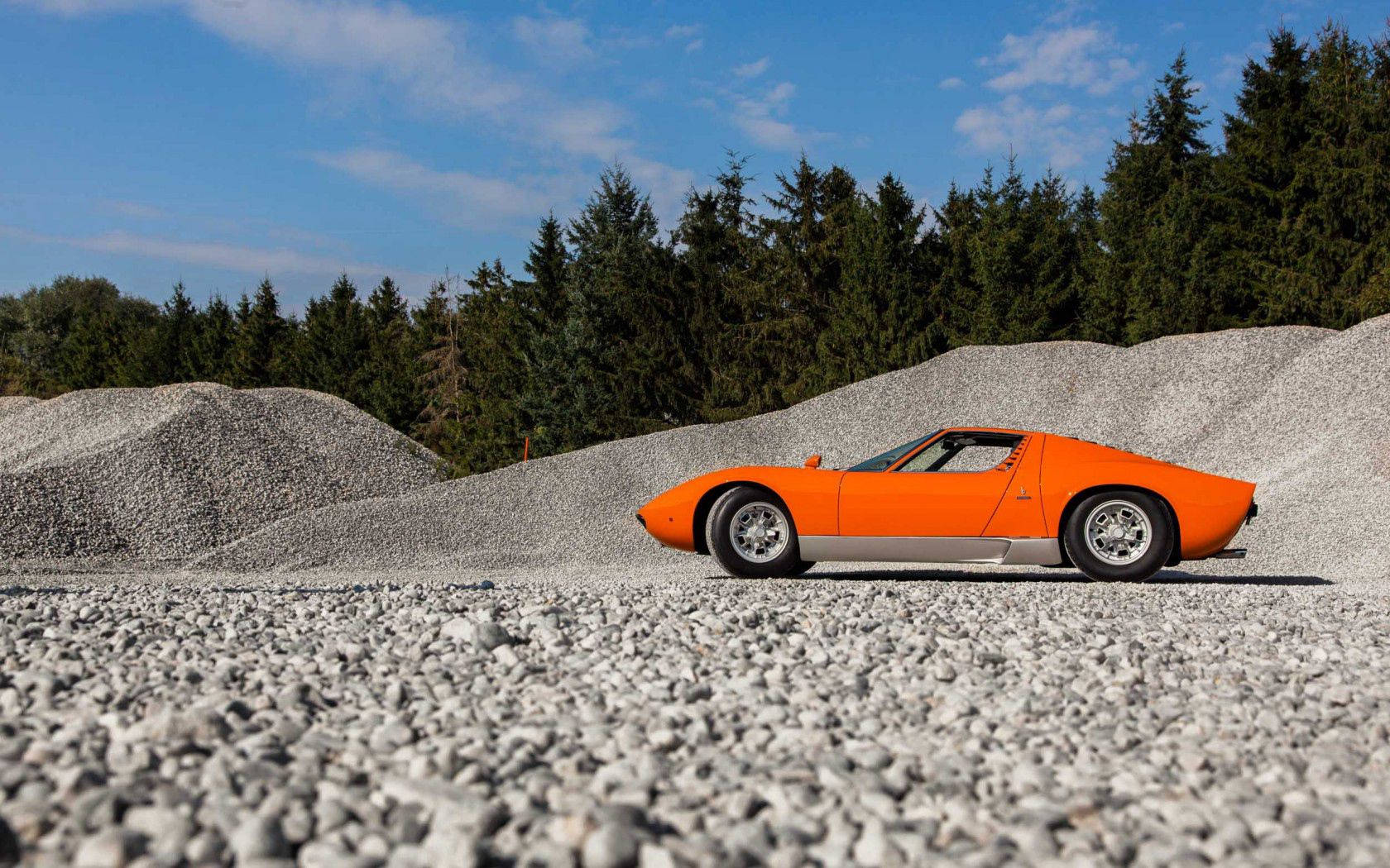 Orange Lamborghini Miura On Gravel Background