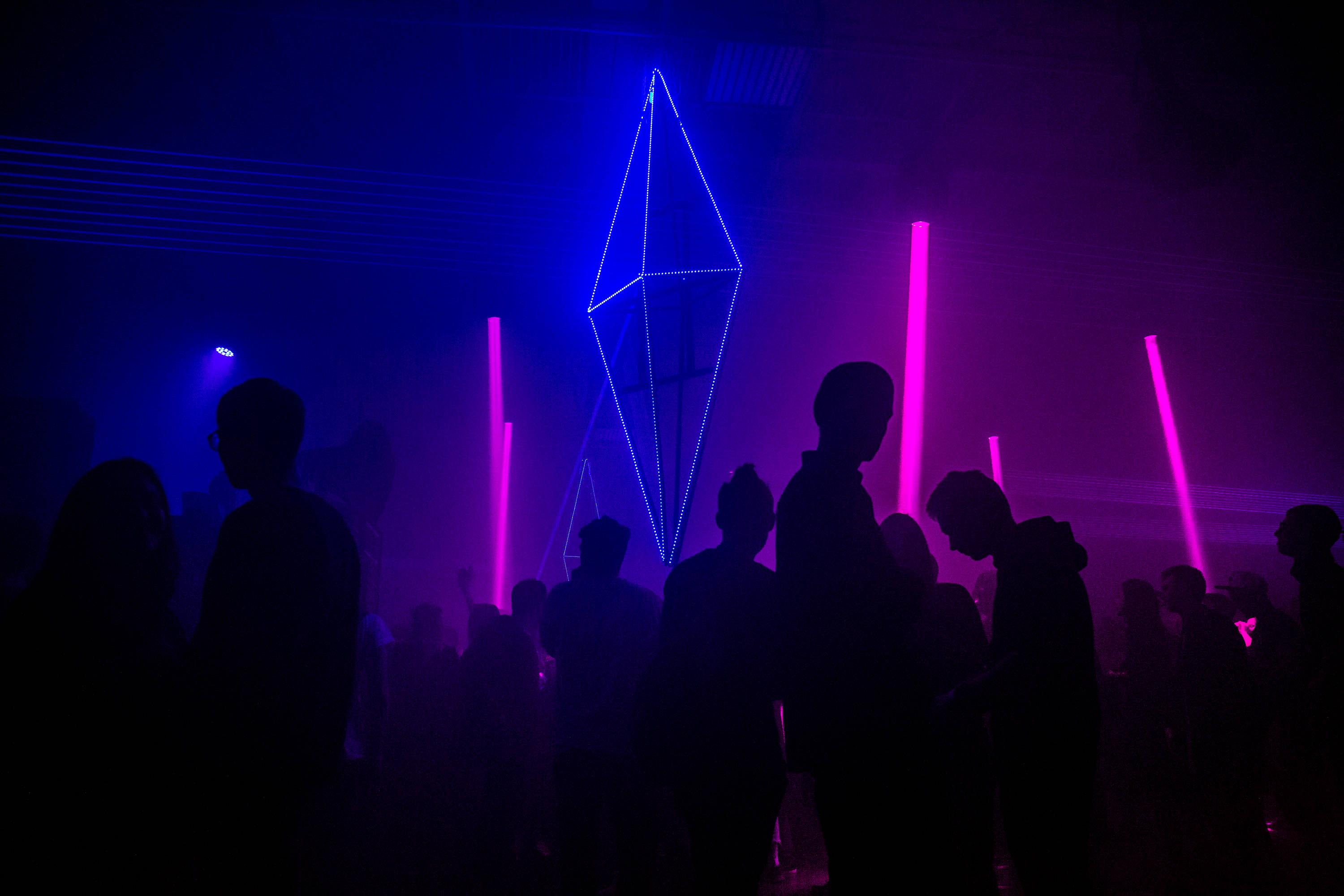 People Under Neon Purple Aesthetic Light Background