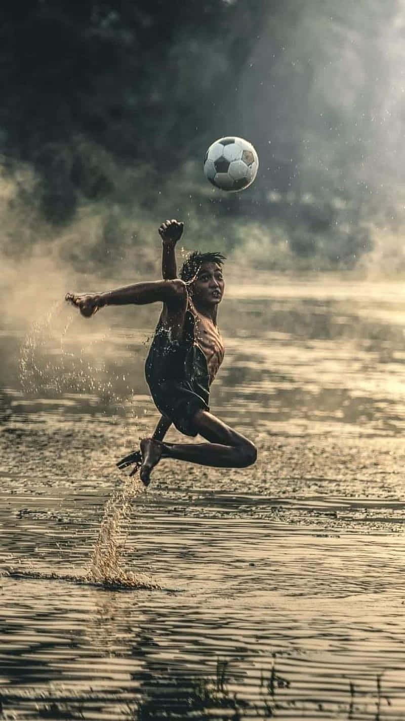 Download Poor Kid Playing Soccer Wallpaper | Wallpapers.com