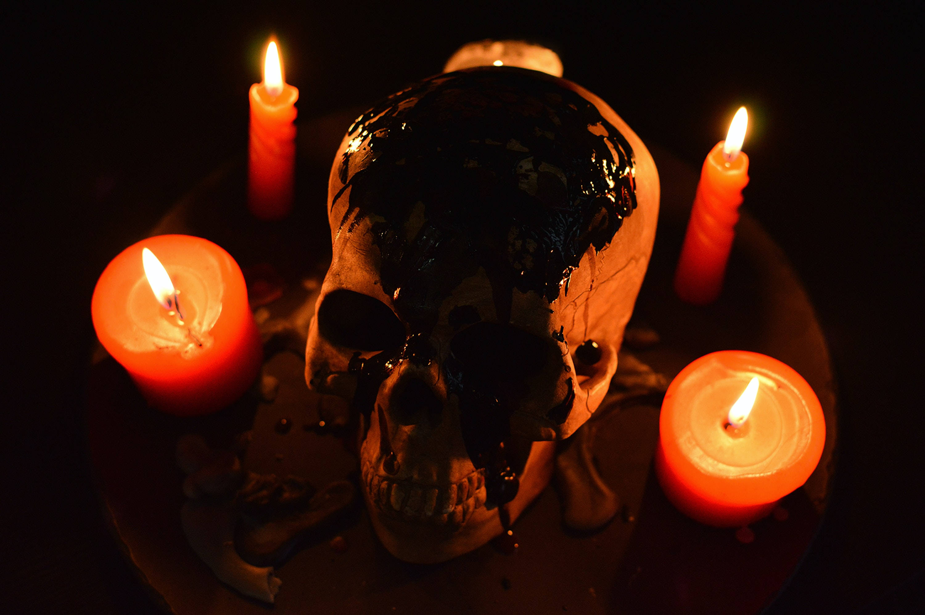 Download Scary Skulls And Lit Candles Wallpaper 