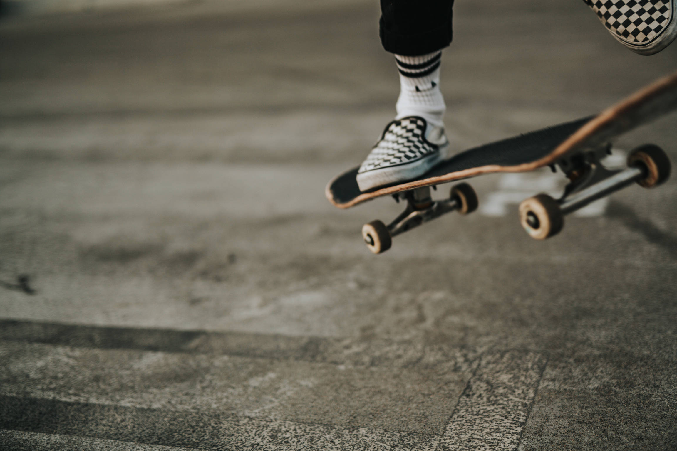 Skater In Vans Checkered Shoes Background