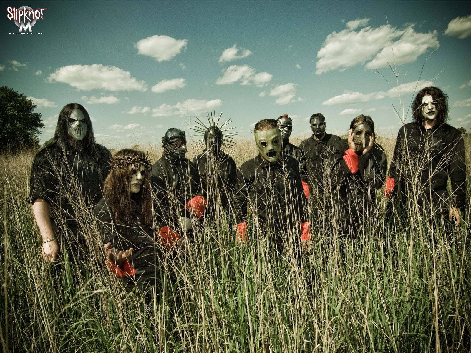 Slipknot Members Standing On Grass Background