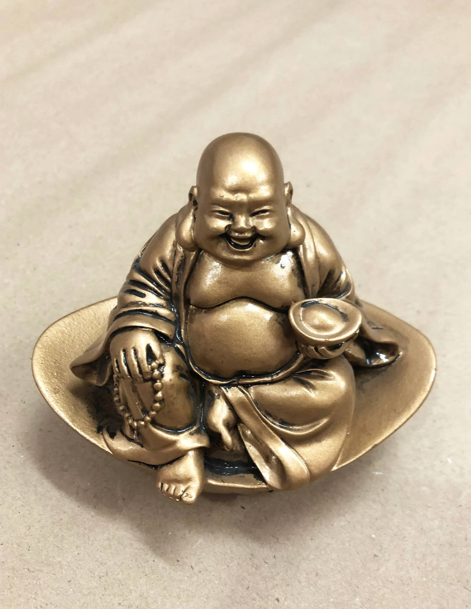 Download Small Laughing Buddha Statue Wallpaper | Wallpapers.com