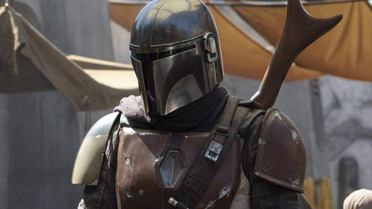 The Mandalorian Is Standing With His Saber Background
