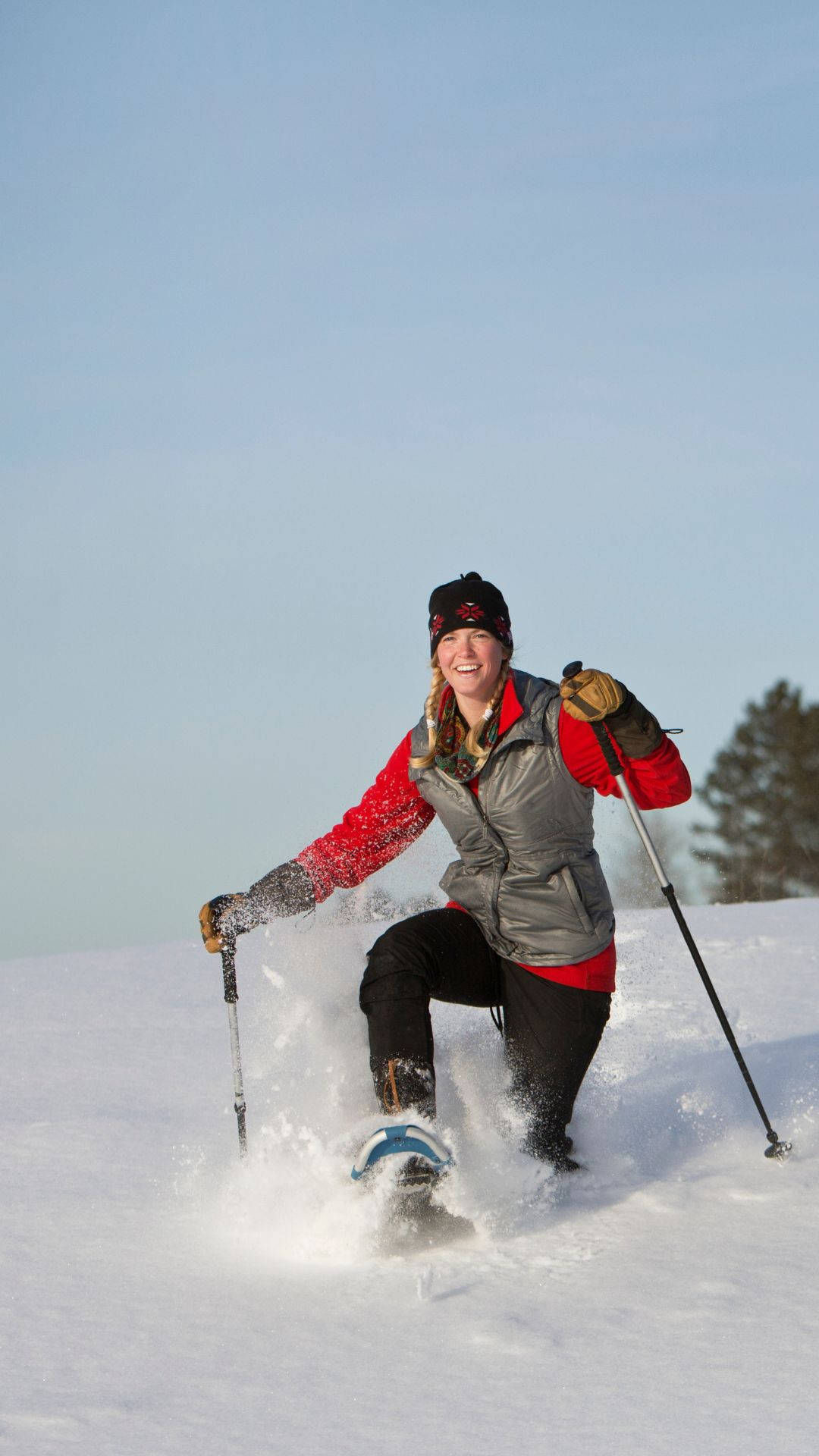 Download Woman Snowshoeing Portrait Wallpaper | Wallpapers.com